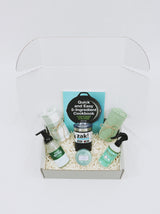 Curated gift box for new home or apartment, including kitchen towels, foaming soap, room spray, Voluspa candle, coffee tumbler, and cook book