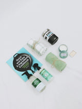 Curated gift box for new home or apartment, including kitchen towels, foaming soap, room spray, Voluspa candle, coffee tumbler, and cook book