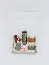 Personalized gift box for men with tech kit, old fashioned cocktail kit, playing cards, coffee tumbler, bottle opener, luggage tag, and unique keys as tools.