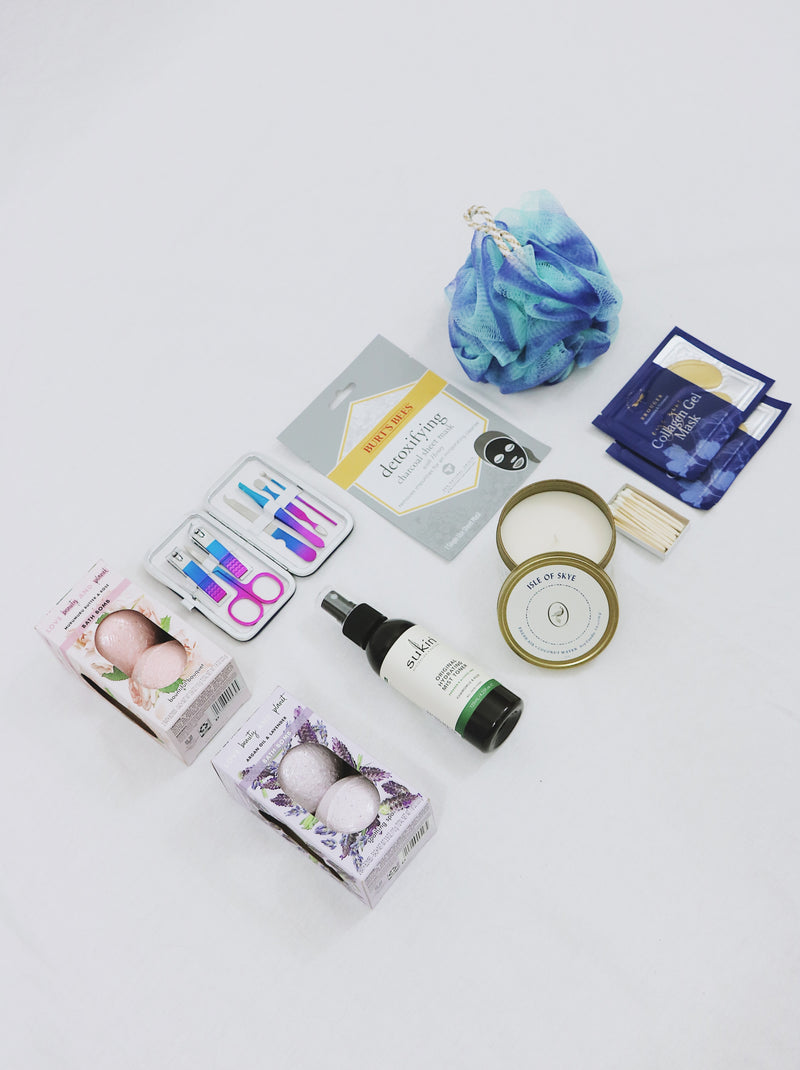 Curated Gift Box for her, including a detoxifying face mask, face spray, travel nail kit, candle, 2 eye masks, lufa and four bath bombs.